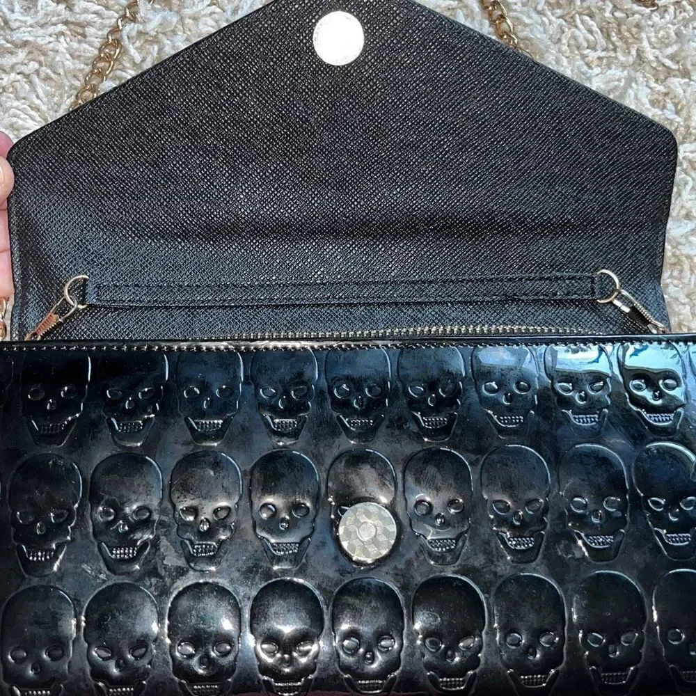 Awesome patent leather skull embossed clutch bag with gold chain shoulder strap.